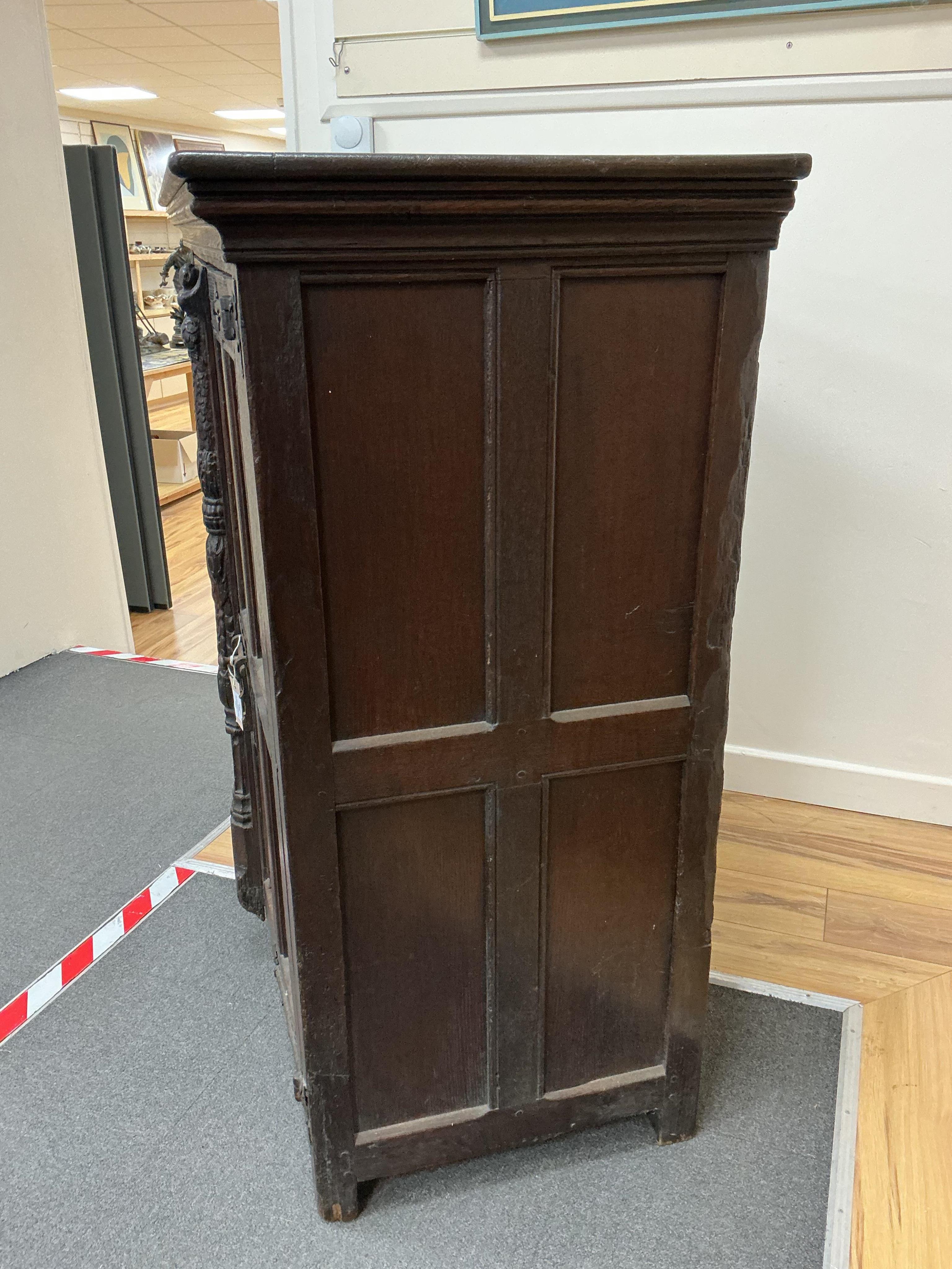 An 18th century and later French carved oak two door cabinet, width 115cm, depth 53cm, height 115cm